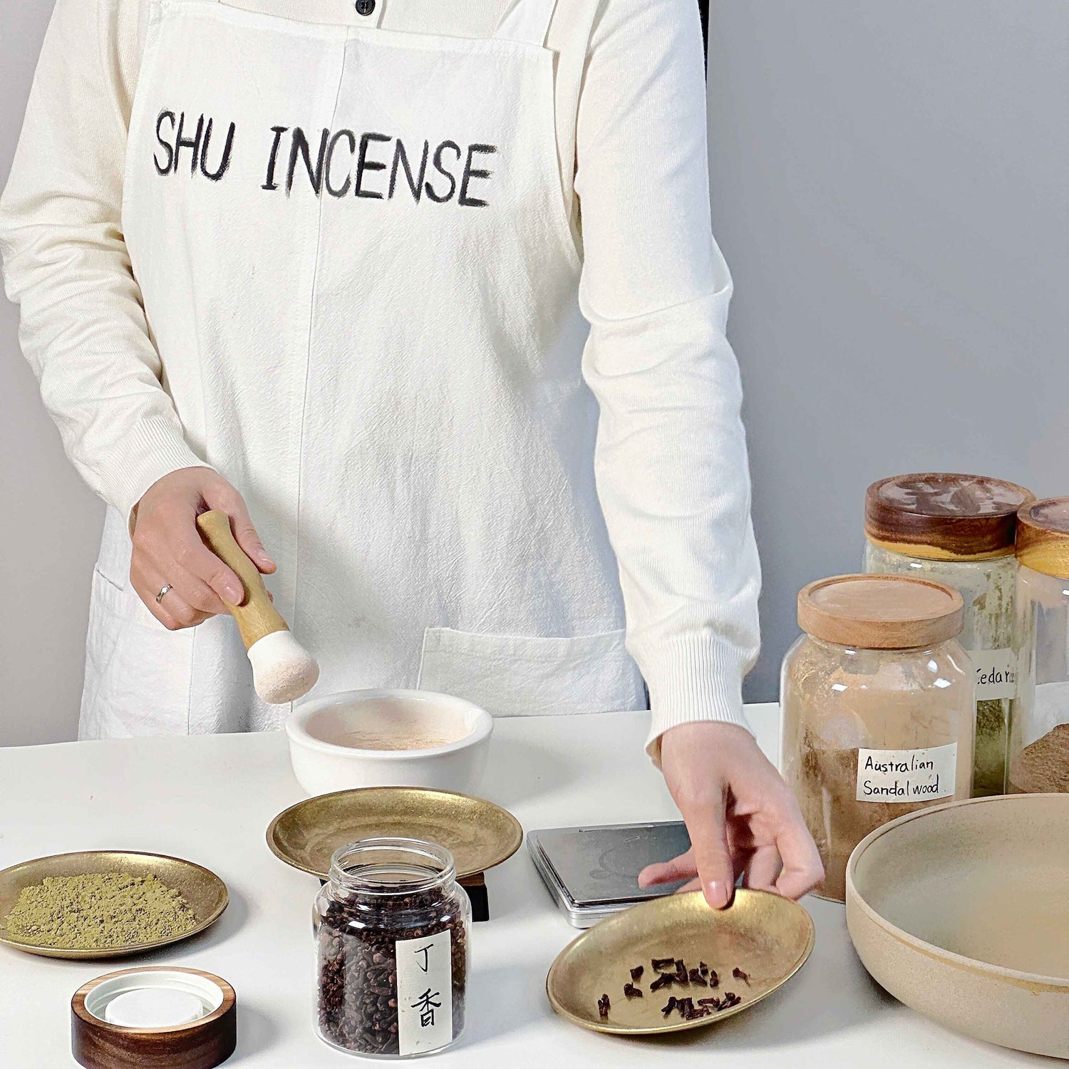 Artisan handcrafting natural incense in SHU INCENSE workshop, blending clove, Australian sandalwood and other botanical ingredients for premium aromatherapy incense.